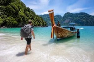 Traditionelles Longtailboot am malerischen Sandstrand für den Ko Muk Urlaub in Thailand
