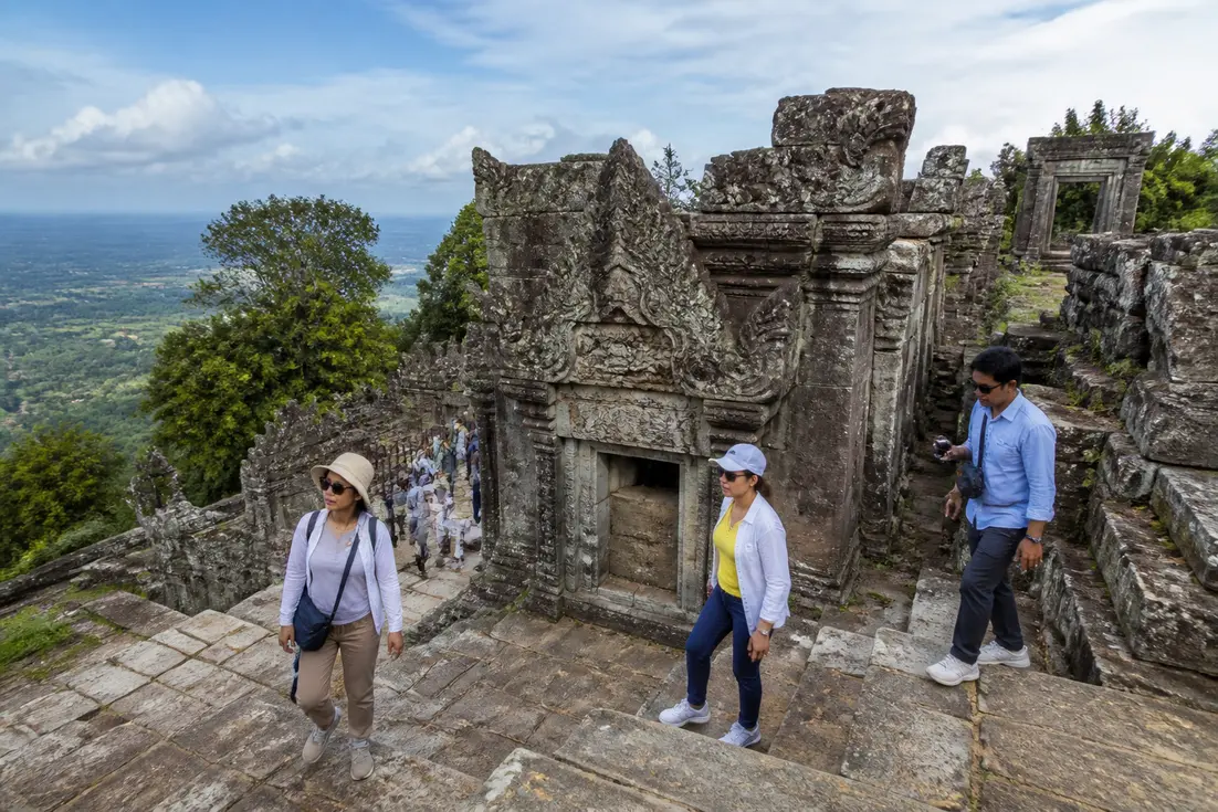 Touristen erkunden die alte Steintreppe und die Ruinen vom preah vihear tempel auf dem Felsen